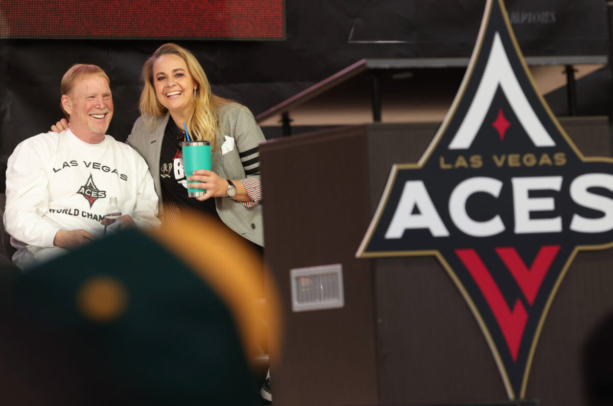 Las Vegas Aces owner Mark Davis and coach Becky Hammon laugh together.